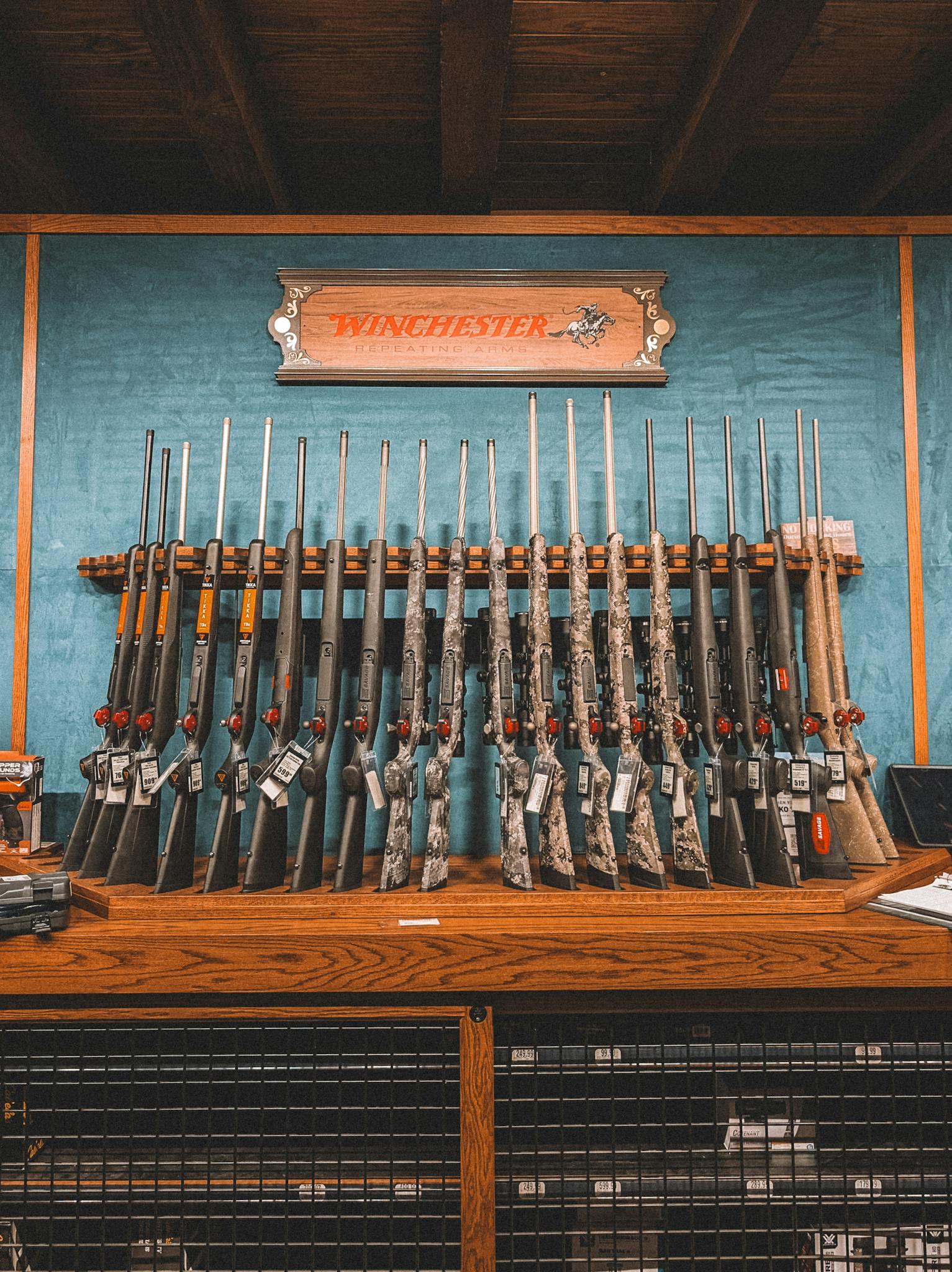 A collection of rifles neatly arranged on a rack in a Winchester store in St. Augustine, Florida.